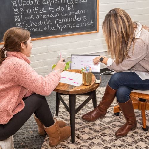 Teenage girl working with female teacher on executive function skills
